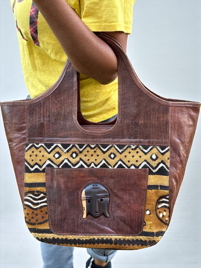 Savanna Spirit Mudcloth Tote – Handmade in Mali with Brown Leather & Ebony Mask Accent (12x20x6)